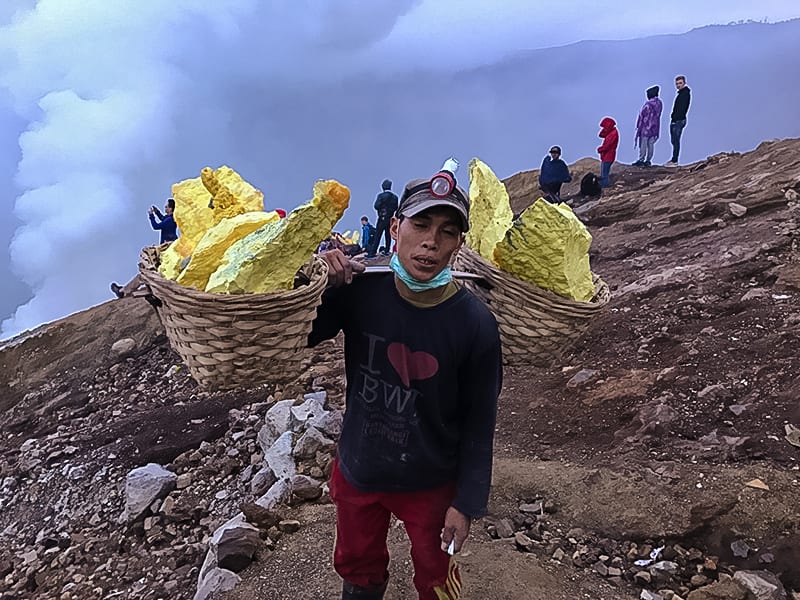 Climbing the Amazing Ijen Volcano in Java to watch the sunrise 9 Sulphur miner on Ijen volcano | The Silver Nomad