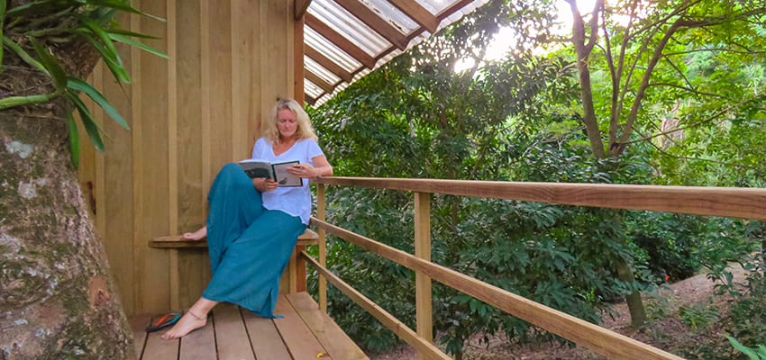 1 Night In The Magical Treehouse At Roland'S Garden Guesthouse, Guanaja 3 Sitting outside the treehouse reading