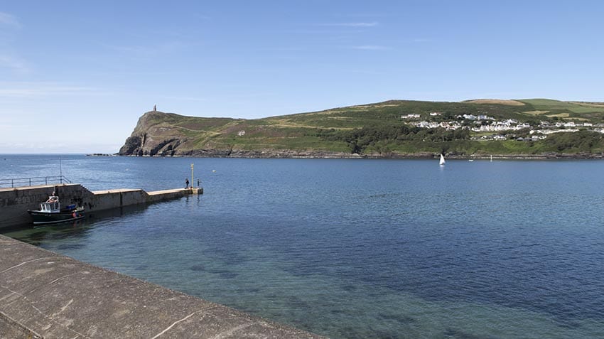 A beautiful day in Port Erin, Isle of Man with the blue sea and great hill in the background
