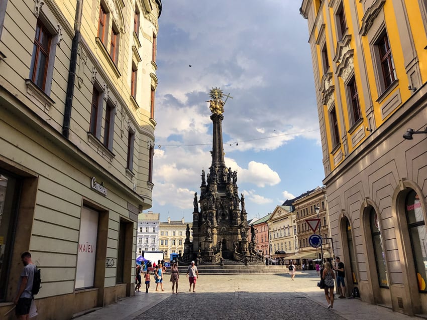 23 Amazing UNESCO Sites in Europe, Off the Beaten Track 12 Holy Trinity Column seen at the end of a street with houses on either side