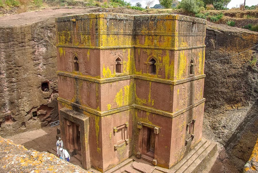 12 Amazing Unesco Heritage Sites In Africa - Off The Beaten Track 12 four storey church carved out of red rock with yellow discolouring on the walls and surrounded by the walls of the mine