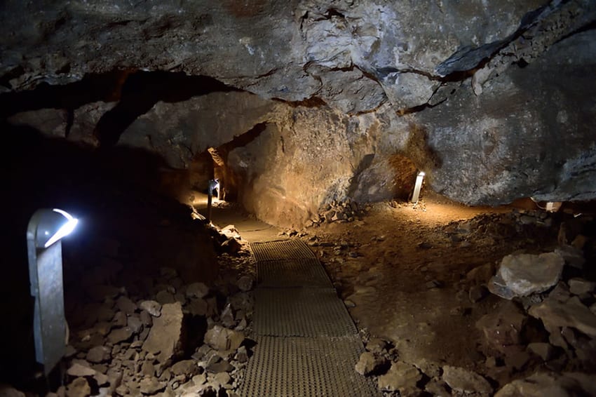 12 Amazing Unesco Heritage Sites In Africa - Off The Beaten Track 4 caves with walkway in the middle and lights on the path