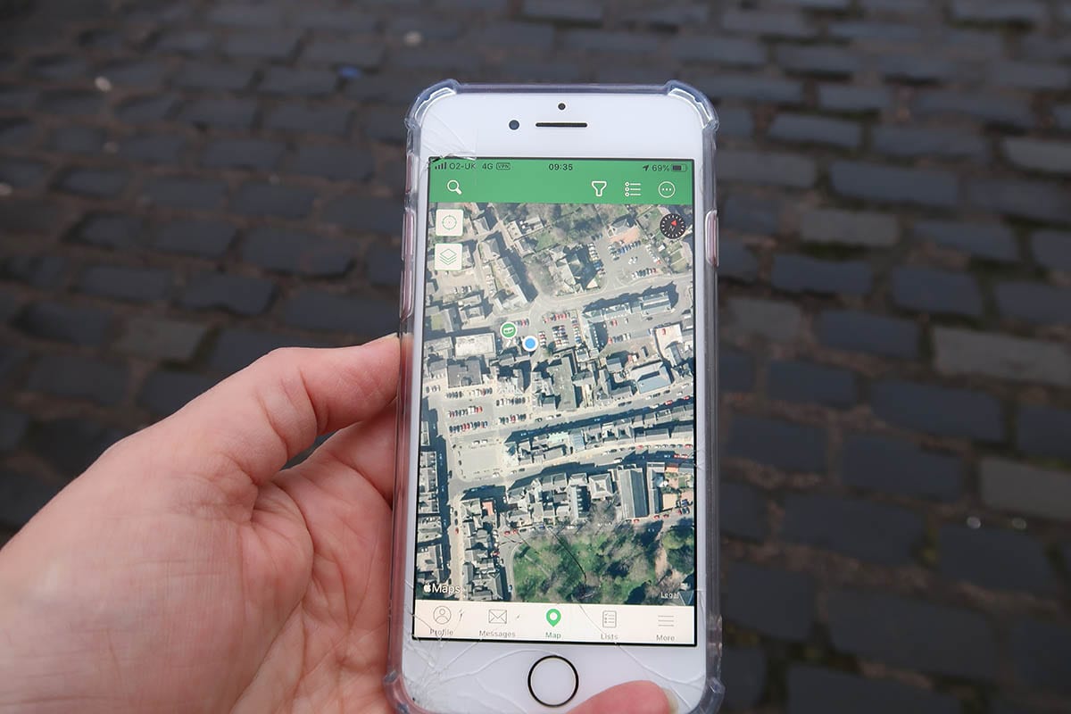 Geocaching, how to be part of the worldwide treasure hunt! 5 Geocaching map shown on an iPhone with a blue dot showing the position of the phone and a green symbol showing where the traditional geocache is