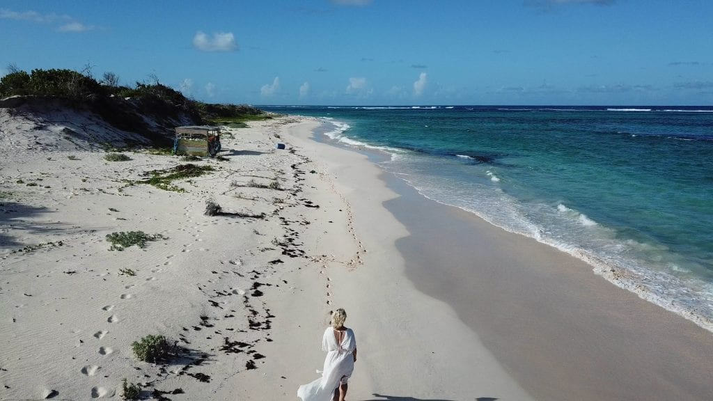 Walking along Frangipani Beach full
