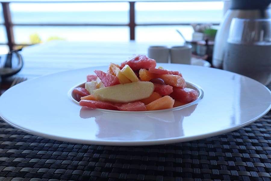 A person standing in front of a body of waterDescription automatically generated