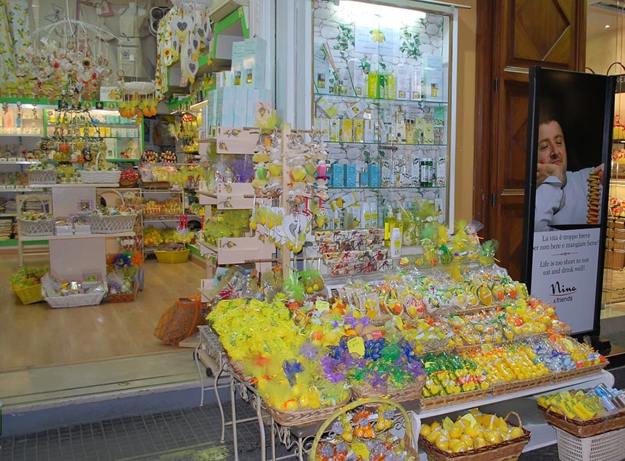 Shop in Sorrento, Italy with baskets of products outside mainly in yellow