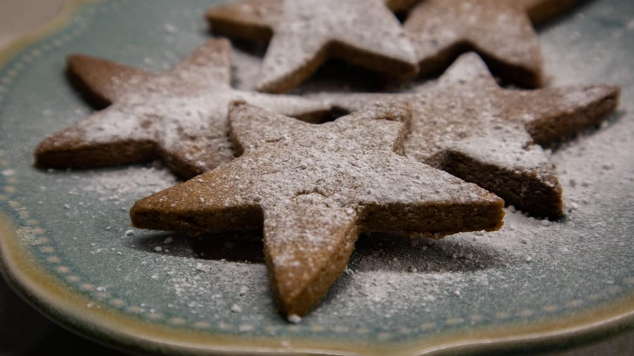 Favourite Christmas Bakes to try this year 2 blue plate with star-shaped Dutch Christmas biscuits dusted with icing sugar