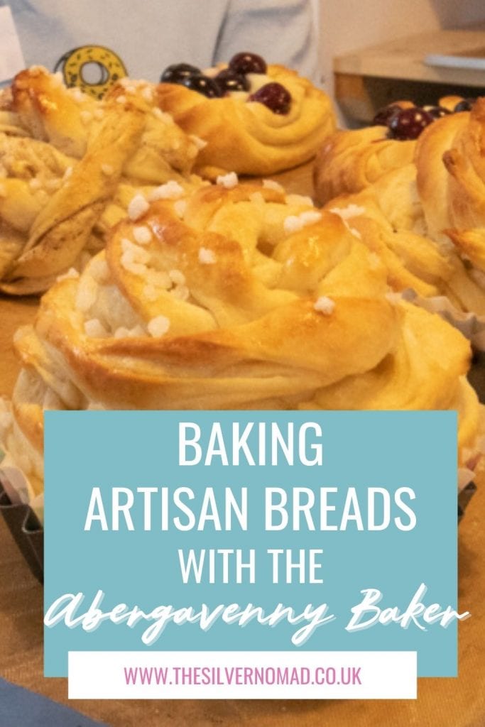 Image of baked sweet buns with white text overlay on pale blue saying Baking Artisan Breads with the Abergavenny Baker