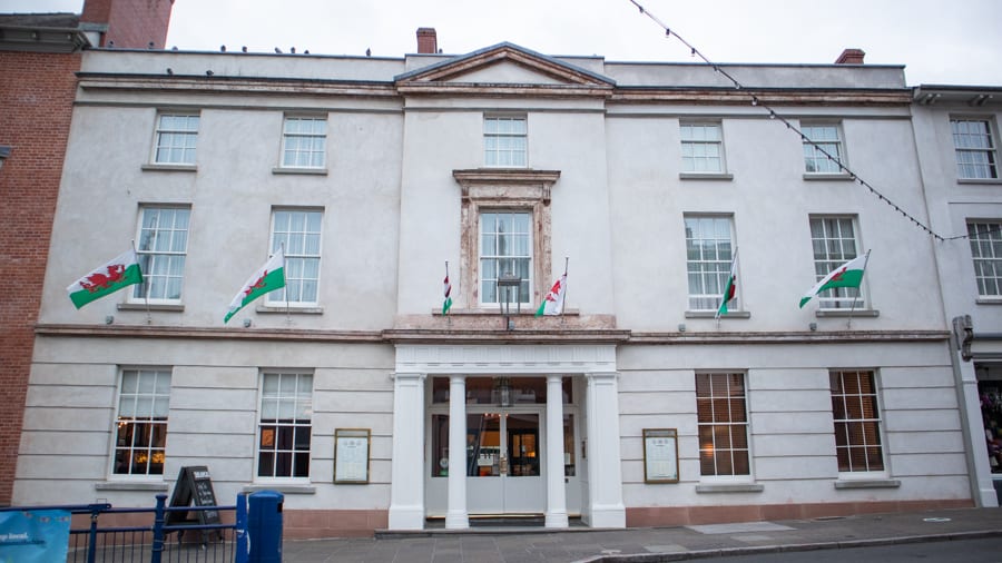 White Georgian facade of Angel Hotel with pillared entrance 