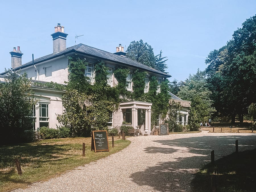 6 Of The Best Weekends In Hampshire, Uk 3 Ivy covered building with two wings and three chimneys and a line of trees to the right