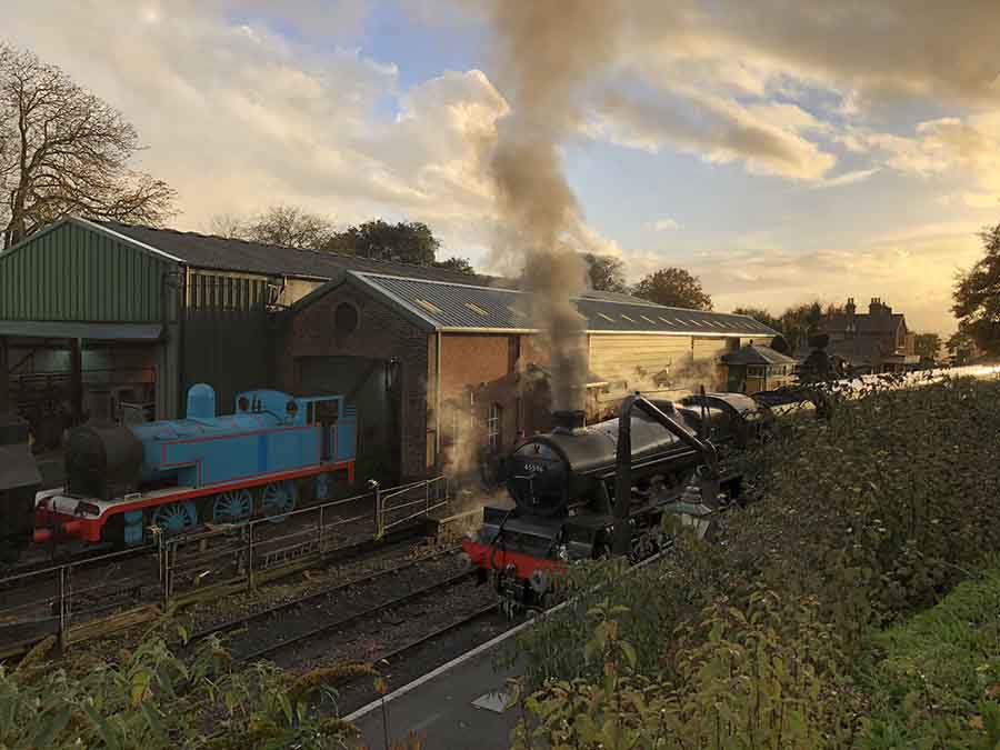6 Of The Best Weekends In Hampshire, Uk 5 railway yard with a black steam train in front and a blue steam train coming out of a shed beside it