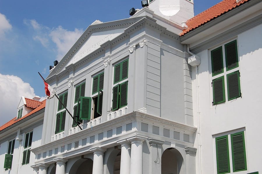 10 Great Reasons To Visit Indonesia 3 White building with green shutters and red roof flying the Indonesian flag