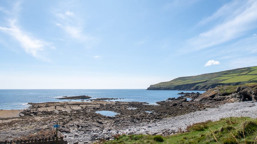 20+ Of The Best Things To Do In Port St Mary, Isle Of Man (2023) 7 Pebble beach below Clifton Road in Port St Mary with hill filled with green fields in the background