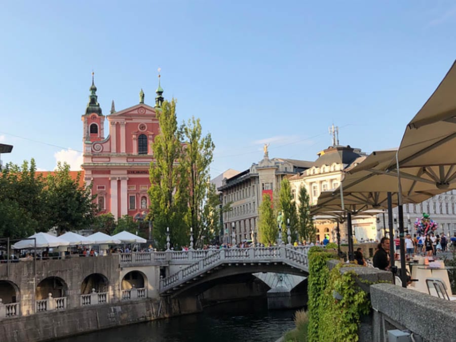 35+ Amazing Hidden Gems In Europe You Must Visit 23 Ljubljana with the river running through the middle and a bridge over it, with buildings in the background