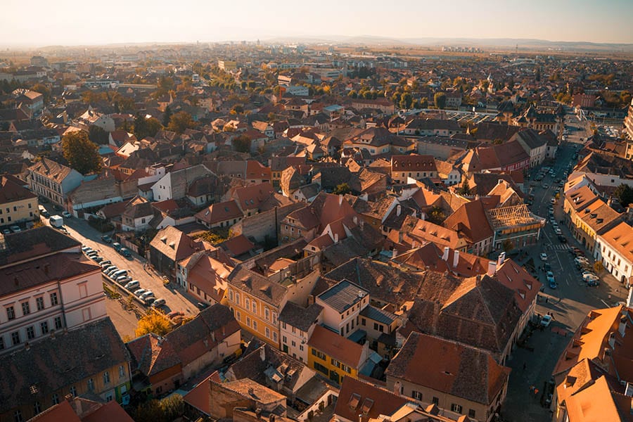35+ Amazing Hidden Gems In Europe You Must Visit 13 an aerial view of the red roofs of Sibiu in Romania