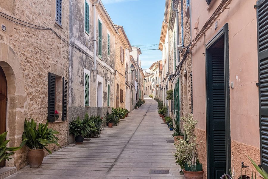 35+ Amazing Hidden Gems In Europe You Must Visit 10 narrow paved street with old stone houses either side