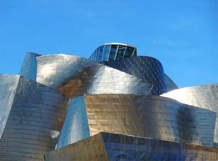 35+ Amazing Hidden Gems In Europe You Must Visit 6 The Guggenheim Museum silver building with curves