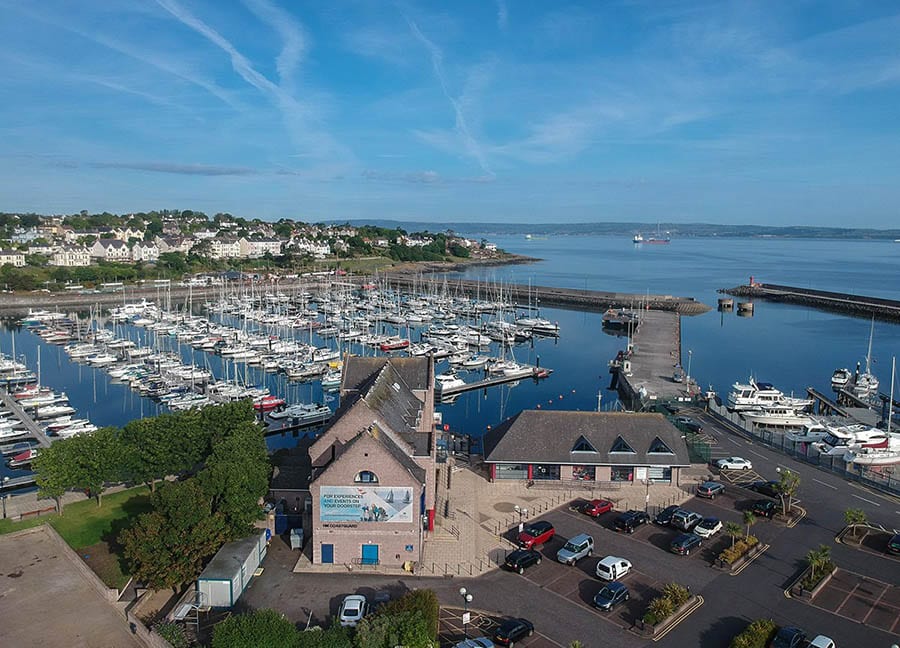 13 Amazing Hidden Gems In Scotland &Amp; Northern Ireland To Discover 14 aerial view of Bangor harbour with lines of yachts and a town in the background