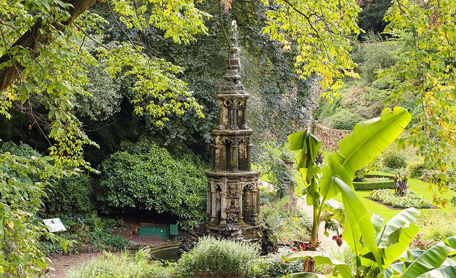 The Absolute Best Cities In The Uk To Visit With Map - (2025) 7 Ornate tower in Plantation Garden in Norwich with banana trees in the foregroun