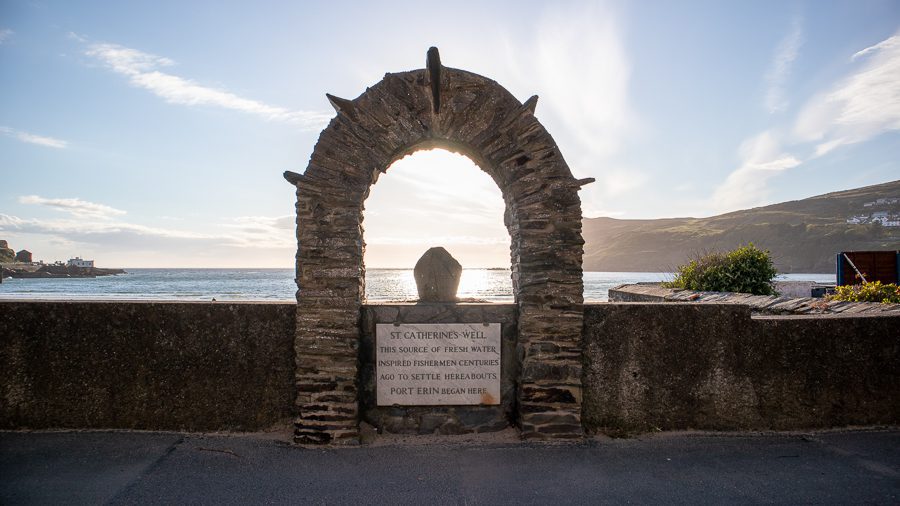 20+ Of The Best Things To Do In Port Erin, Isle Of Man (2023) 2 Arch above sign which says "St Catherine's Well, the source of fresh water inspired fishermen centuries ago to settle hereabouts. Port Erin Began Here," one of the things to do in Port Erin