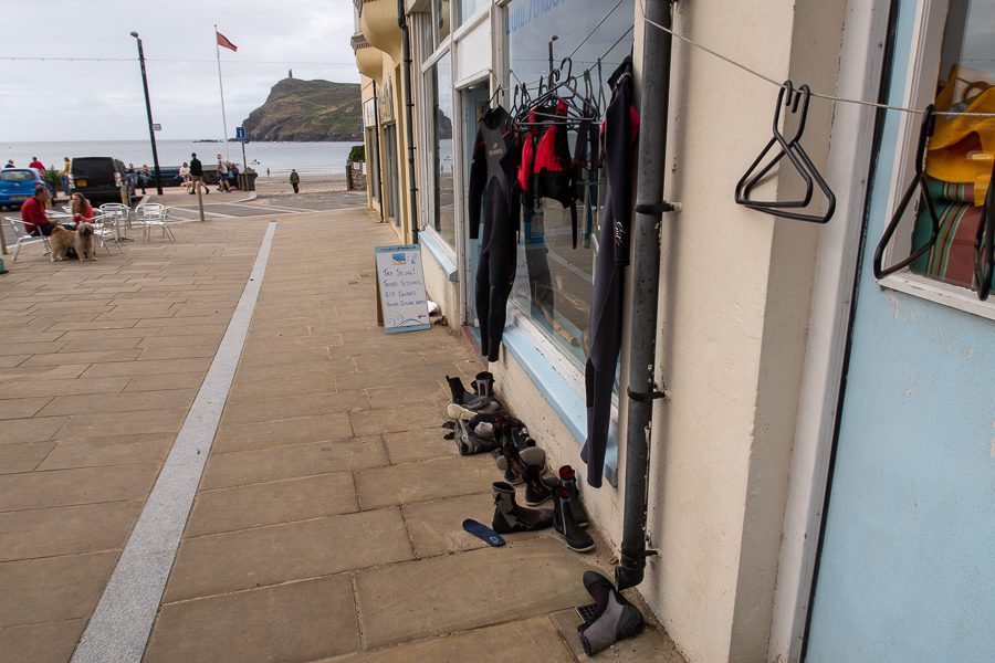 20+ Of The Best Things To Do In Port Erin, Isle Of Man (2023) 4 The outside of 7th Wave in Port Erin with Wetsuits hanging up