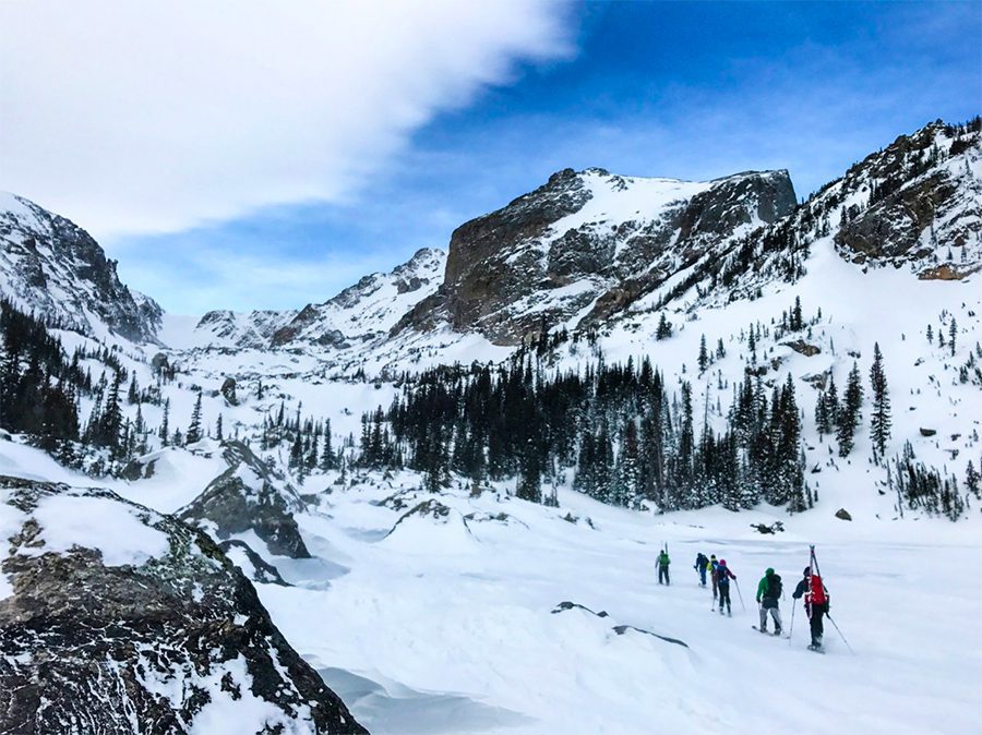22 Amazing Destinations For Winter Snow Around The World 6 Rocky Mountain with skiers walking in the snow