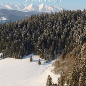Pine trees dusted with snow on a snowy hill with a range of snow covered mountains in the background and Discover Amazing Destinations for Winter Snow around the World on top