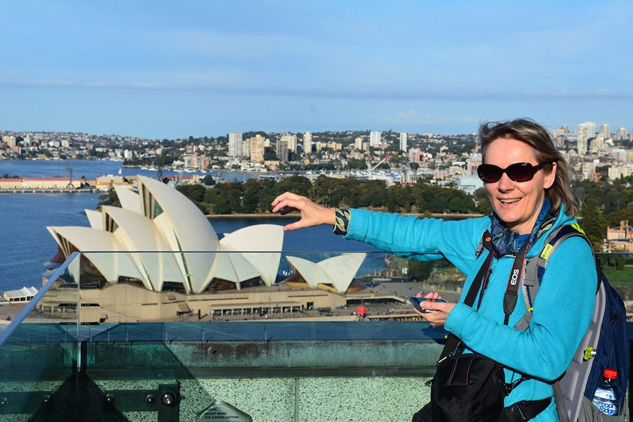 Celebrating 16 Awesome Mature Bloggers In 2021 To Inspire You 14 Michaela from Rocky Travel Blog in Sydney trying to hold the Sydney Opera House