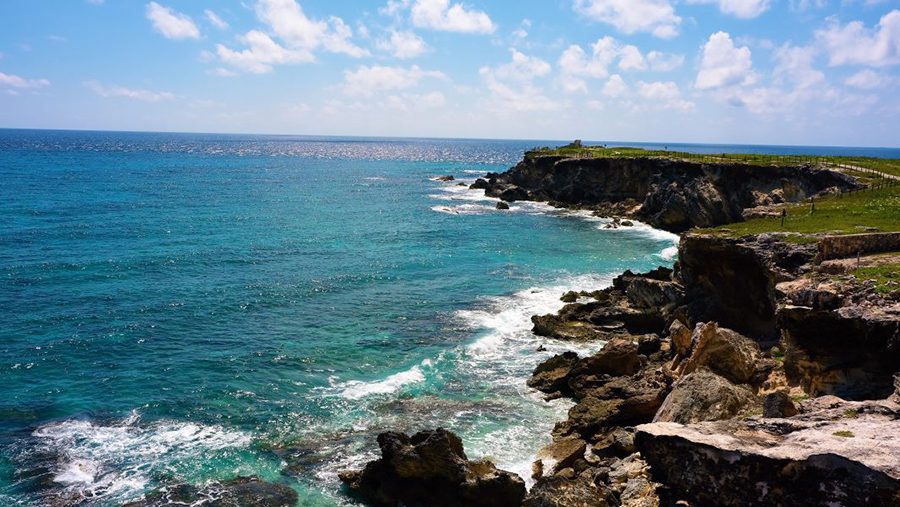 25 Amazing Destinations For Winter Sun Around The World 15 Punta Sur Ruins to Ixchel with the sea on the left and the cliffs with the pathway on the right