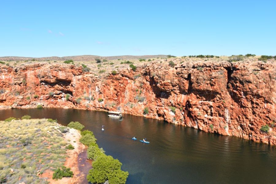 25 Amazing Destinations For Winter Sun Around The World 26 Yardie Creek with kayakers paddling down the creek surrounded by red rock cliffs