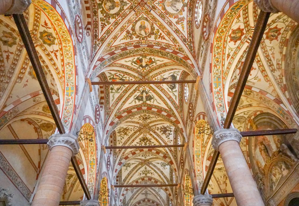 Stunning UNESCO Sites in Italy to discover in 2023 17 the ornate ceiling of Verona church with highly decorates arches above the columns