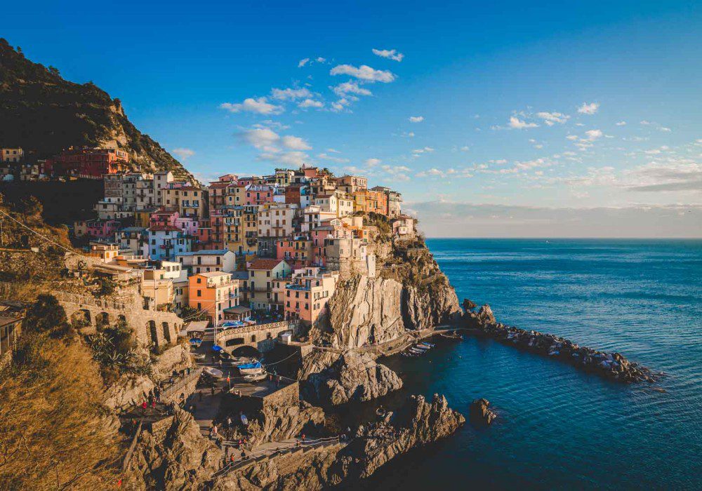 Stunning UNESCO Sites in Italy to discover in 2023 12 The multicoloured painted buildings of Cinque Terre above the bay and sea