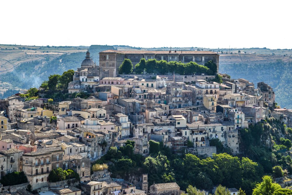 Stunning UNESCO Sites in Italy to discover in 2023 19 Hilltop town of Ragusa with cream coloured buildings down the sides and monastery on top