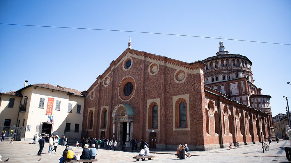 Stunning UNESCO Sites in Italy to discover in 2023 2 The Church of Santa Maria delle Grazie, a red brick church with a found tower to the rear one of the Unesco Heritage Sites in Italy