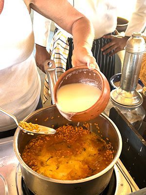 The Best Food In Sri Lanka To Eat (Including 5 Easy Recipes!) 26 pouring the coconut milk into the dhal