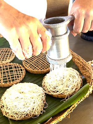 The Best Food In Sri Lanka To Eat (Including 5 Easy Recipes!) 23 using a press, pressing out the white string hopper