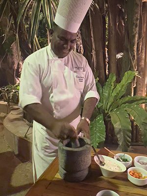 The Best Food In Sri Lanka To Eat (Including 5 Easy Recipes!) 28 chef in whites mixing ingredients in a grey pestle and mortar