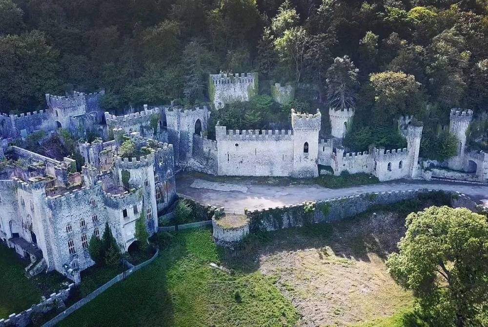 The crenalated Gwrych Castle with round towers and square towers