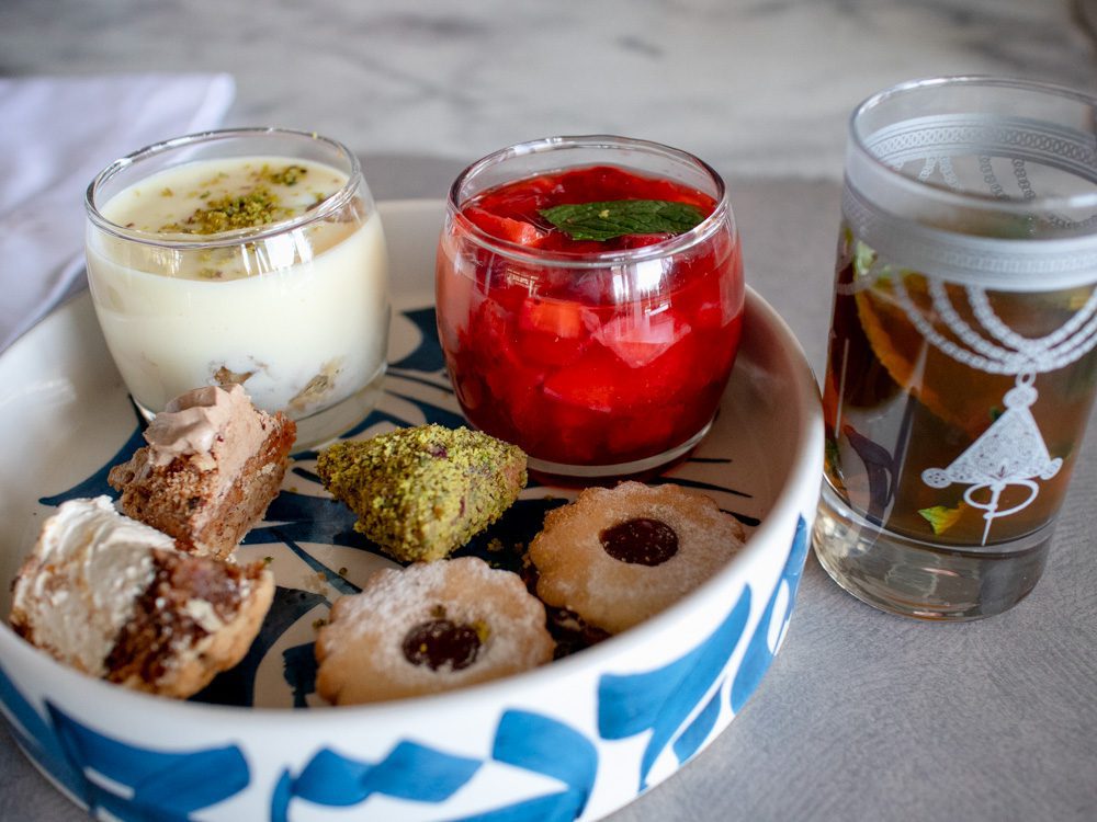 Sawa Taste of Tunisia: Explore the amazing food of Tunisia (2024) 56 Selection of puddings in blue and white bowl with mint tea in a painted glass