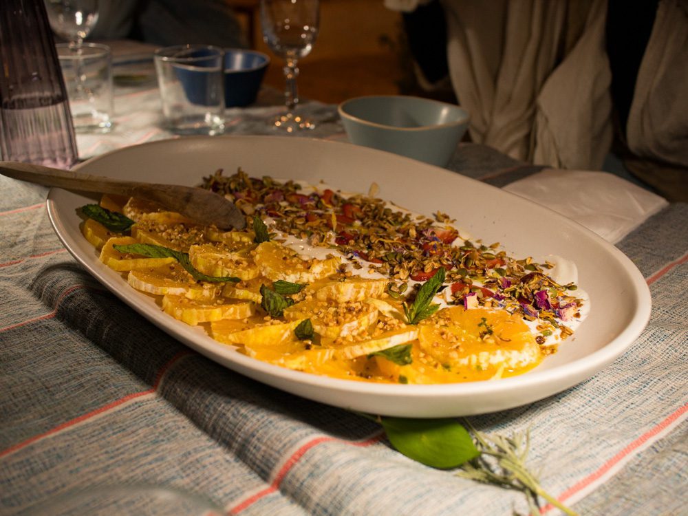 Sawa Taste of Tunisia: Explore the amazing food of Tunisia (2024) 60 dessert with yoghurt, orange slices rose and pistachios on a white platter