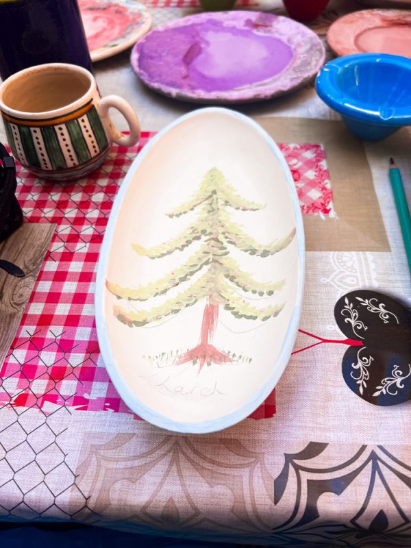 Sawa Taste of Tunisia: Explore the amazing food of Tunisia (2024) 14 oval plater with a larch tree painted on it in greens and browns