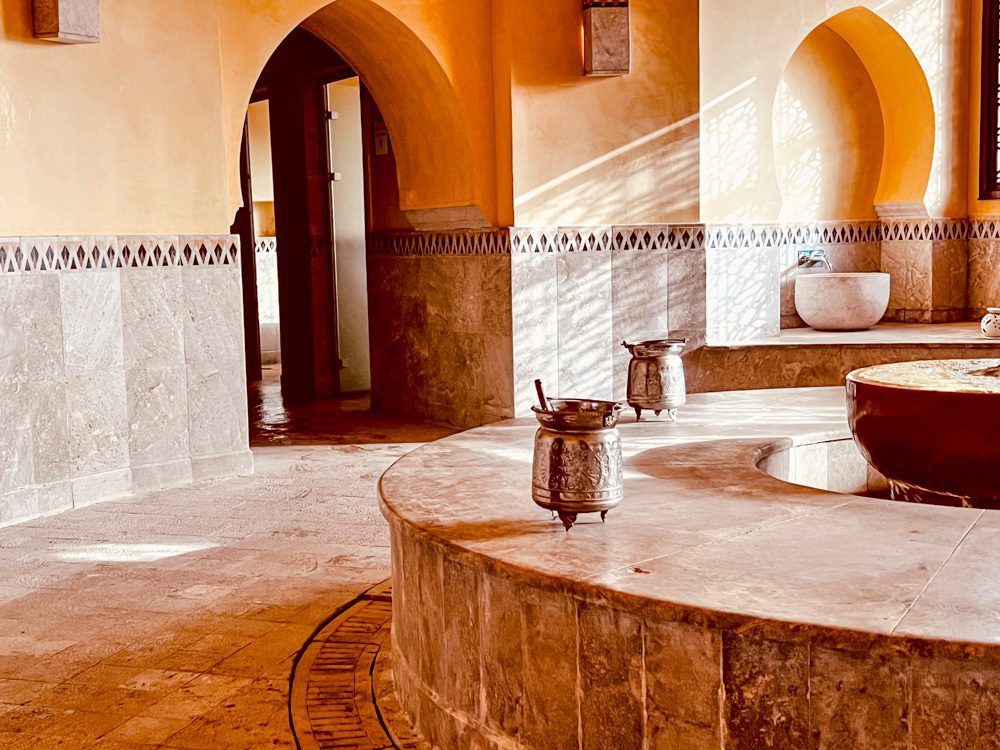 a large stone bathtub with a large bowl on the side