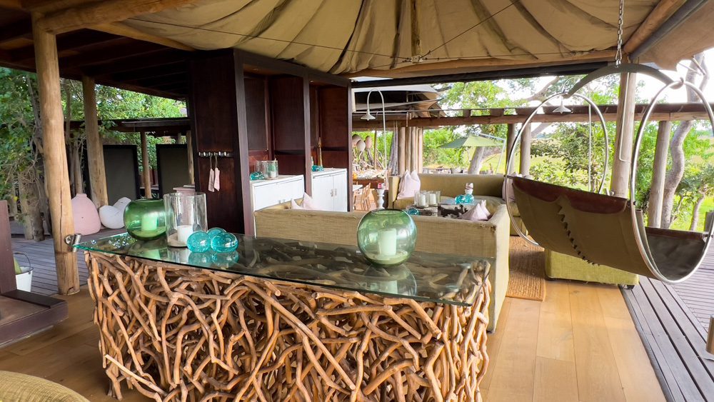 The Luxurious Xaranna Camp By &Amp;Beyond, Okavango Delta, Botswana (2024) 22 the hanging swing next to the wood and glass table