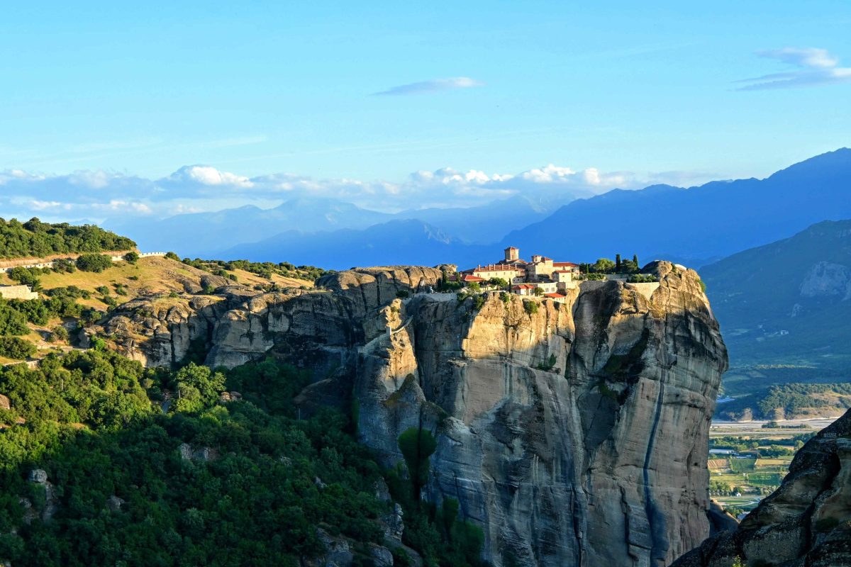 Meteora at sunset sitting on top of the cliff