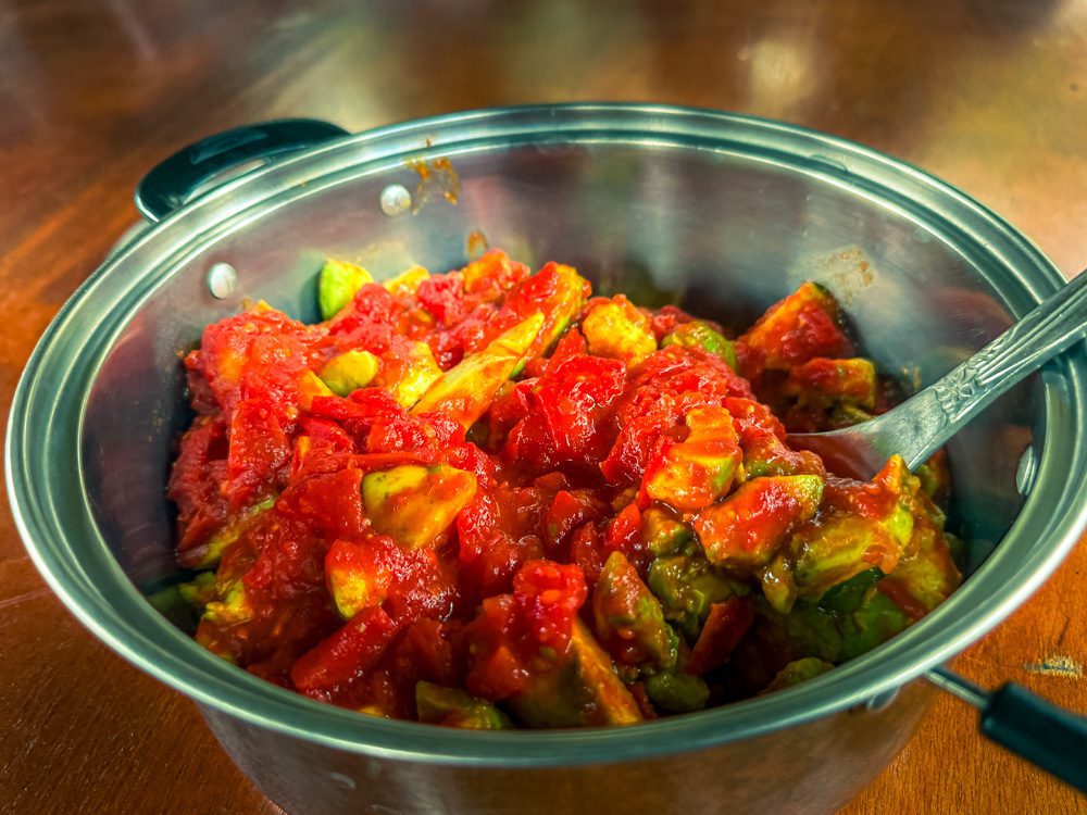 Avocado and Tomato Salsa in a silver metal dish with spoon