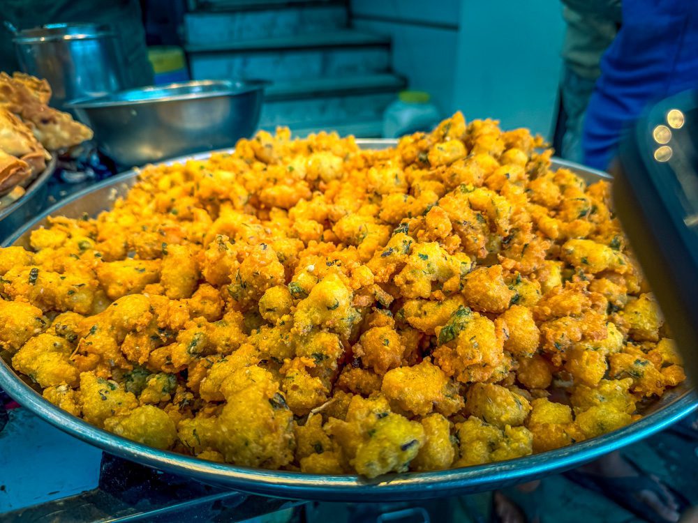 freshly made vegetable pakora on a silver platter