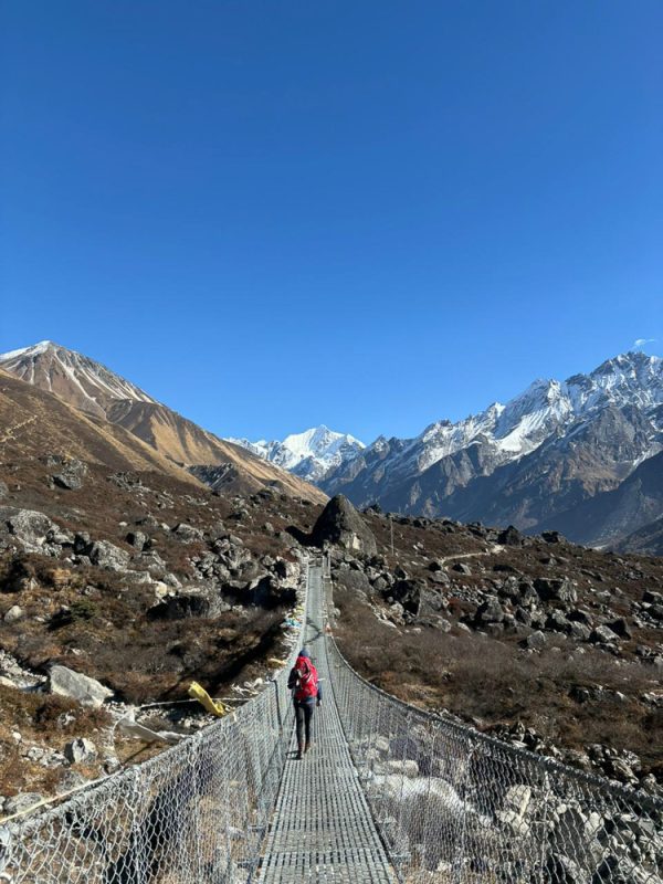 The 5 Best Treks In Nepal For Travellers Over 40 3 Hiker crossing a suspension bridge on Langtang Valley Trek